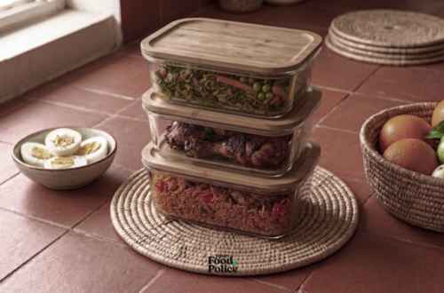 Tiled counter with stacked glass containers of jollof rice, chicken, and greens, showing meal prep for a busy schedule